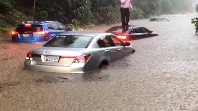 Rains strand Washington drivers, flood White House basement