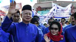 Malaysia’s Najib, wife banned from leaving country